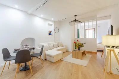 a living room with a couch and a table at Cocon charmant et paisible au cœur du Vieux Nice in Nice