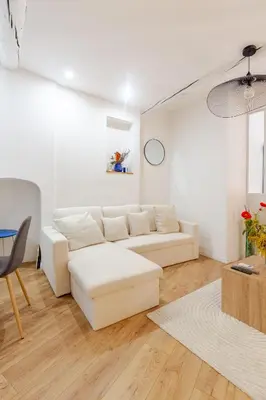 a white living room with a white couch and a table at Cocon charmant et paisible au cœur du Vieux Nice in Nice