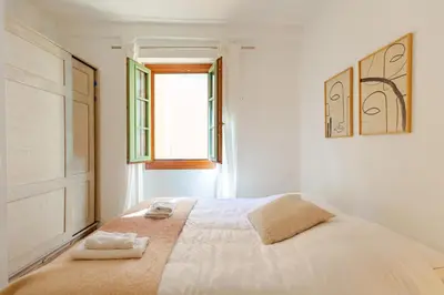 a bedroom with a bed with two towels on it at Cocon charmant et paisible au cœur du Vieux Nice in Nice