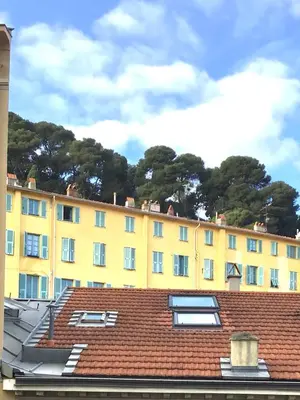 a yellow building with a red tile roof at Nice port quartier antiquaire in Nice
