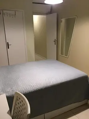 a bedroom with a bed and a mirror at Nice port quartier antiquaire in Nice