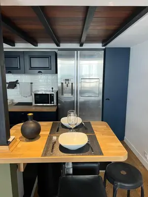 a kitchen with a wooden table with two plates on it at loft riviera in Nice