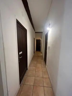 a hallway with a door and a tile floor at Studio nel cuore della città in Nice