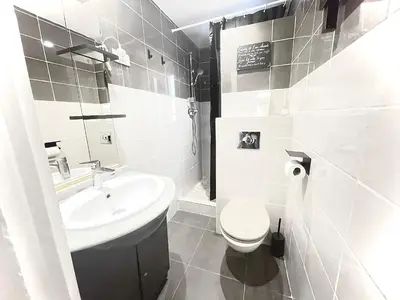 a white bathroom with a sink and a toilet at Cosy Family trip in Nice