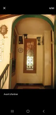 a hallway with a door and a window in a building at Chambre au calme sur les collines in Nice