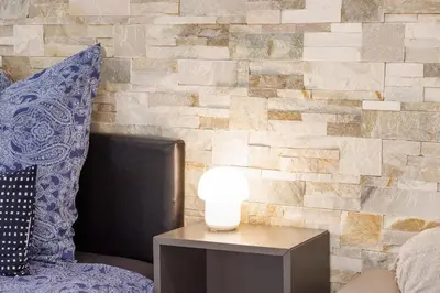 a lamp on a table in front of a brick wall at Nice Renting - PENCHIENATTI - Chic & Modern Urban Pearl Massena Old Nice in Nice