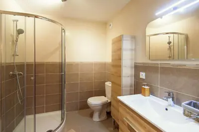 a bathroom with a toilet and a shower and a sink at Villa Serafina Apartements in Nice