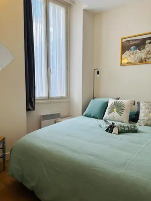 a bedroom with a large green bed with a window at New ! Charmant spacieux 2p Vieux-Nice calme in Nice