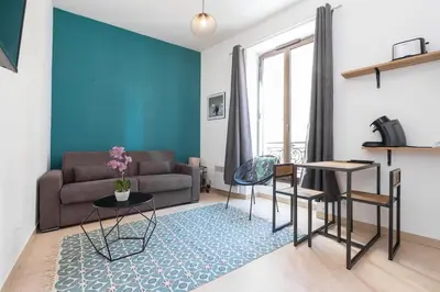 a living room with a couch and a table at Superbe studio Nice hyper centre immeuble standing in Nice