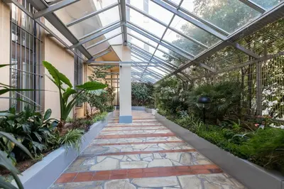 a glass greenhouse with a pathway in a garden at Superbe studio Nice hyper centre immeuble standing in Nice