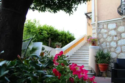 a set of stairs with flowers in front of a house at Villa Mon Rêve Apartements in Nice