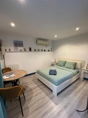 a bedroom with a bed and a table and a table sidx sidx sidx at Villa Mon Rêve Apartements in Nice