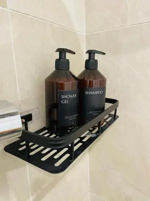a shelf in a bathroom with two bottles of shampoo at Magnifique 2 pièces - Vieux Nice in Nice