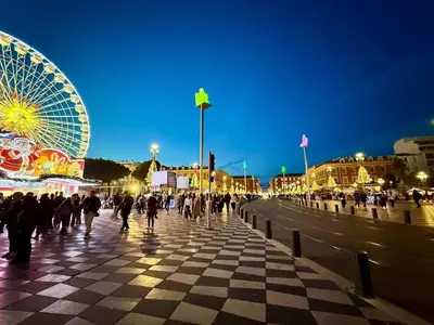 a crowd of people walking on a pier with a ferris wheel at Magnifique 2 pièces - Vieux Nice in Nice