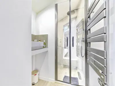 a bathroom with a shower and a glass door at Hyper Centre - Charming duplex - Luxury - Reversible air conditioning - 10 mins from Place MASSENA in Nice