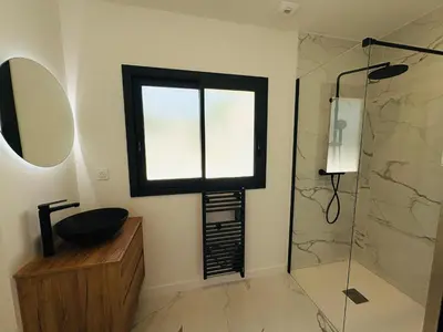 a bathroom with a window and a sink and a shower at L'Esprit Sud, 4 Suites & Piscine Chauffée in Vence