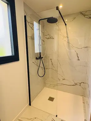 a shower with a glass door in a bathroom at L'Esprit Sud, 4 Suites & Piscine Chauffée in Vence