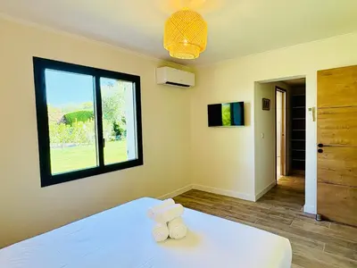 a bedroom with a bed with two towels on it at L'Esprit Sud, 4 Suites & Piscine Chauffée in Vence
