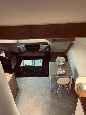 a small living room with a couch and a table at Duplex Élégant au Cœur de Nice in Nice