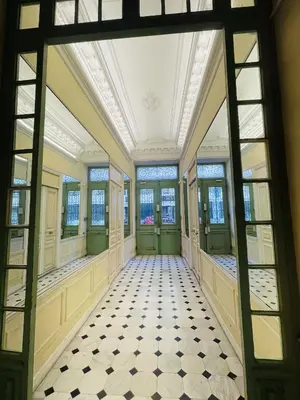 an empty hallway in a building with windows at Duplex Élégant au Cœur de Nice in Nice