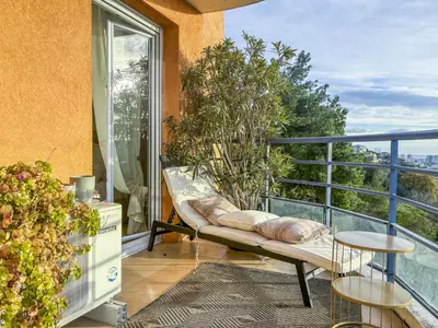 a balcony with a bench and a window at Evasion vue mer - Wifi, Piscine, Parking, 4pers in Nice