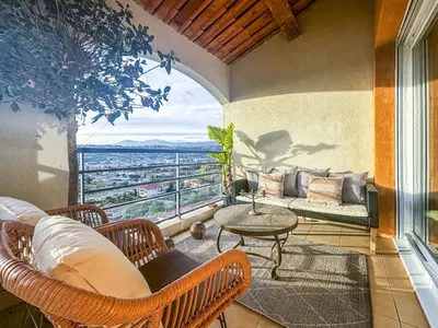 a balcony with a table and chairs and a view at Evasion vue mer - Wifi, Piscine, Parking, 4pers in Nice