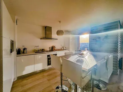 a kitchen and dining room with a table and chairs at Evasion vue mer - Wifi, Piscine, Parking, 4pers in Nice
