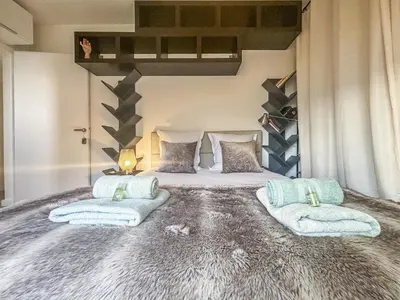 a bedroom with a large bed with towels on it at Evasion vue mer - Wifi, Piscine, Parking, 4pers in Nice