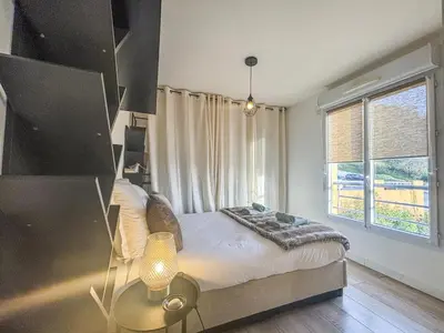 a bedroom with a bed and a large window at Evasion vue mer - Wifi, Piscine, Parking, 4pers in Nice