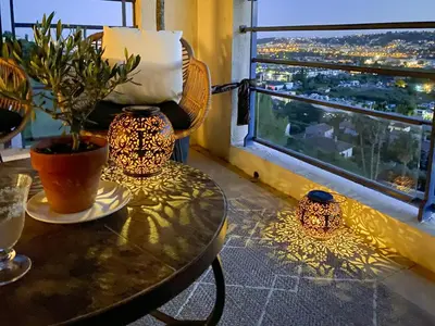 a table with a potted plant and a window with a view at Evasion vue mer - Wifi, Piscine, Parking, 4pers in Nice