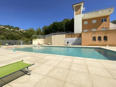 a swimming pool in front of a building at Evasion vue mer - Wifi, Piscine, Parking, 4pers in Nice