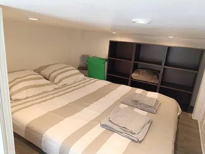a bedroom with a bed with two towels on it at Studio climatisé in Nice