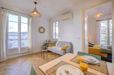 a living room with a table and a couch at Maison Bianchi - Avenue Durante - Downtown Top floor in Nice