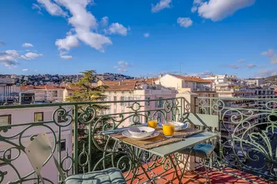 a table on a balcony with a view of a city at Maison Bianchi - Avenue Durante - Downtown Top floor in Nice