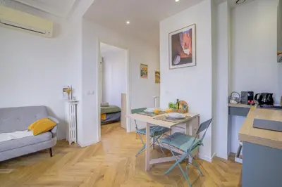 a small living room with a table and a couch at Maison Bianchi - Avenue Durante - Downtown Top floor in Nice