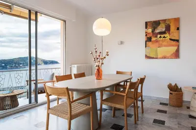 a dining room with a table and chairs at LE SAINT ESTEVE AP4435 By Riviera Holiday Homes in Villefranche-sur-Mer