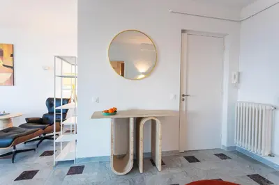 a room with a table and a mirror on the wall at LE SAINT ESTEVE AP4435 By Riviera Holiday Homes in Villefranche-sur-Mer