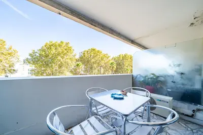 a white table and chairs on a balcony at Superbe 3 pieces Nice 100m de la mer in Nice