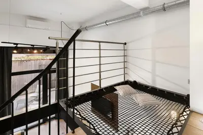 a room with a balcony with a bed at Loft Industriel avec Terrasse et Filet Suspendu à Nice Cimiez in Nice