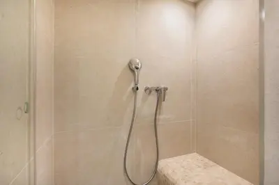a shower with a shower head in a bathroom at Loft Industriel avec Terrasse et Filet Suspendu à Nice Cimiez in Nice
