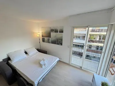 a bedroom with a bed and a large window at ⁂ Calme et ensoleillé balcon quartier Port Nice in Nice
