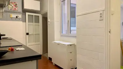 a kitchen with a white refrigerator and a window at ApartHotel Riviera - COCON BARILLERIE - Old Town - Promenade des Anglais in Nice