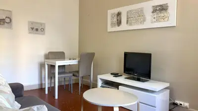 a living room with a tv and a desk with a tvictericter at ApartHotel Riviera - COCON BARILLERIE - Old Town - Promenade des Anglais in Nice