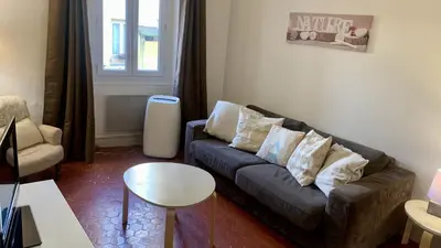 a living room with a couch and a table at ApartHotel Riviera - COCON BARILLERIE - Old Town - Promenade des Anglais in Nice