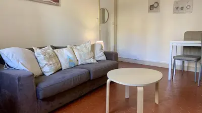 a living room with a couch and a table at ApartHotel Riviera - COCON BARILLERIE - Old Town - Promenade des Anglais in Nice
