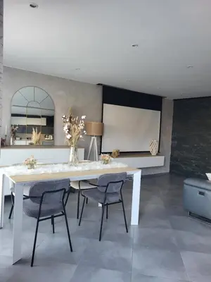 a dining room with a white table and chairs at Maison entre mer et montagnes in La Gaude