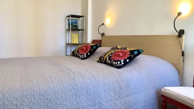 a bedroom with a bed with two pillows on it at ApartHotel Riviera - CLOCHER D'ALEXANDRE - Old Town - Promenade des Anglais in Nice