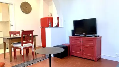 a living room with a red dresser with a flat screen tv at ApartHotel Riviera - CLOCHER D'ALEXANDRE - Old Town - Promenade des Anglais in Nice