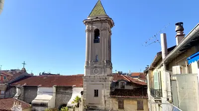 a tall tower with a steeple on top of a building at ApartHotel Riviera - CLOCHER D'ALEXANDRE - Old Town - Promenade des Anglais in Nice