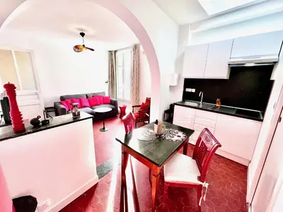 a kitchen and living room with a table and chairs at ApartHotel Riviera - CLOCHER D'ALEXANDRE - Old Town - Promenade des Anglais in Nice